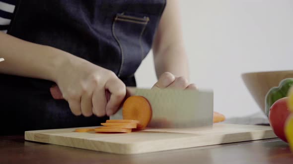 chief woman making salad healthy food and chopping bell pepper on cutting board.