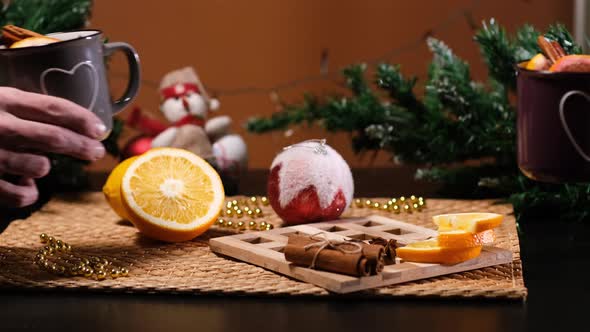 Man and Woman Clinking Mugs with Mulled Wine