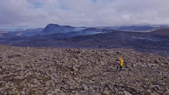 View of the Mountains With Smoke Coming Underneath Cloudy Skies in Background