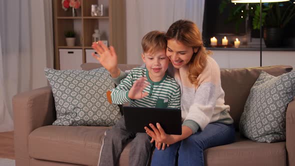 Mother and Son with Tablet Pc Having Video Call