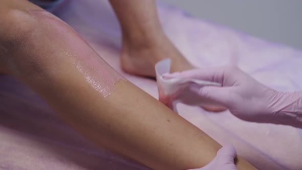 Beautician Doing Wax Procedure for Hair Removal in Salon