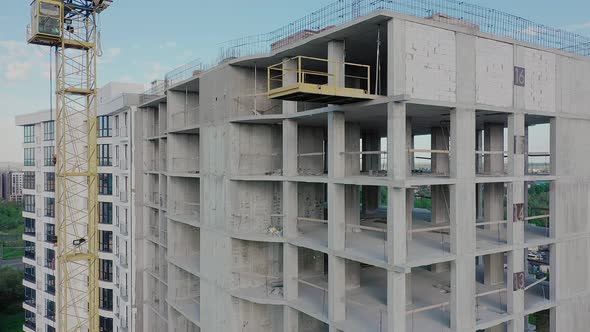 Aerial view of high residential apartment building under construction. Real estate development.