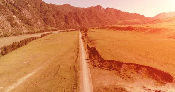 Aerial Rural Mountain Road and Meadow at Sunny Summer Morning