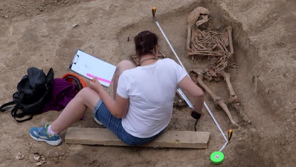 Young Archeologist Works on an Archaeological Site at Morning Sun Rays at Summer Heat
