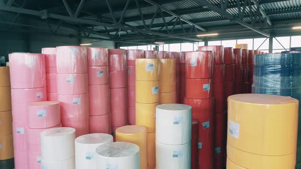 Many Colorful Paper Rolls Stored at a Big Warehouse