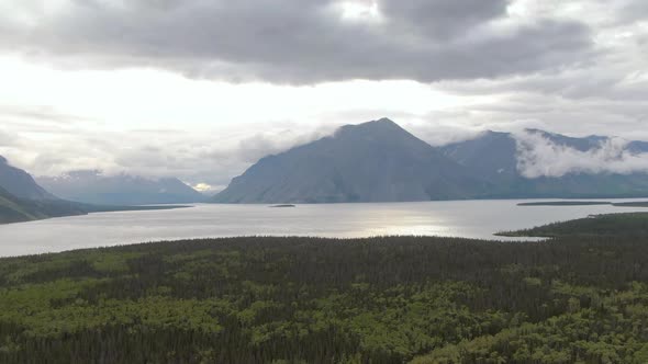 View of Scenic Lake Surrounded By Forest and Mountains