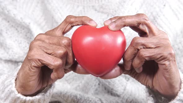 Senior Women Holding Red Heart Close Up