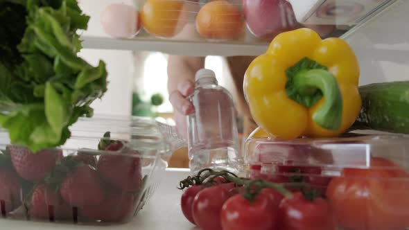 View Inside the Refrigerator Hand Takes Bottle From the Refrigerator Version 2