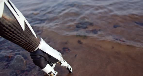 Closeup of the Bionic Arm of a Disabled Person Against the Background of Water