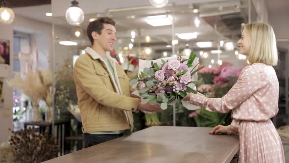 Woman Florist Seller Gives Flower Bouquet To Man Customer
