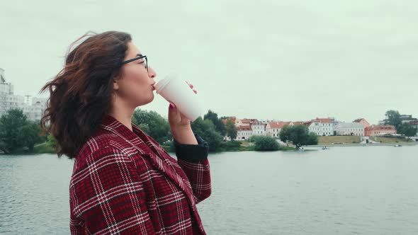 a Young Girl Drinks Coffee in the Fresh Air