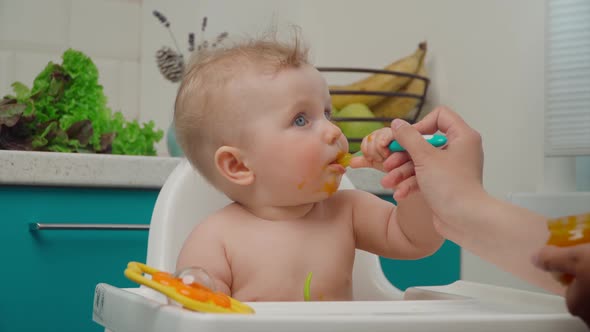 Baby Boy Eating Yellow Mashed Food