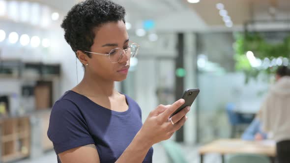Portrait of Casual African Woman Using Smartphone 