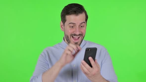 Portrait of Man Celebrating on Smartphone Green Screen