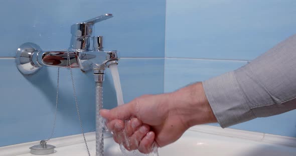 Man Is Switching on Single Lever Mixer Tap in Bathroom,opening Water, Soaping Hand and Washing