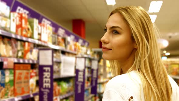 Thoughtful woman shopping for grocery