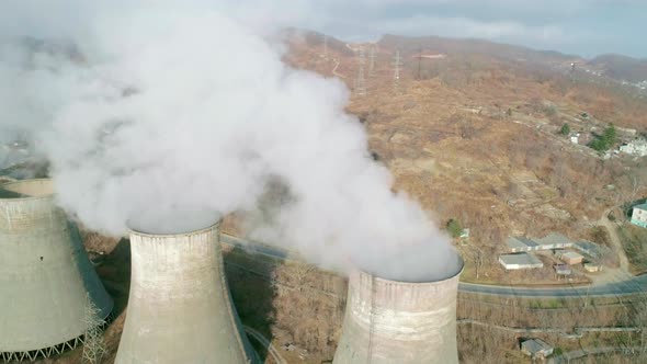 Aerial Orbital View of an Industrial Zone Pipes Pouring Thick White Smoke