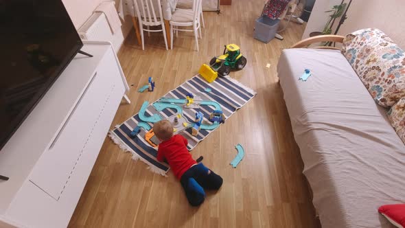 Boy With Tablet Lying On The Floor