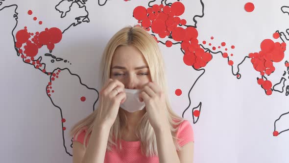 Beautiful Woman in Medical Mask and World Map That Shows Spreading of Coronavirus.