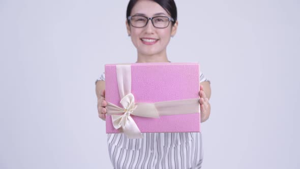 Happy Beautiful Asian Businesswoman Giving Gift Box