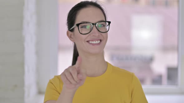 Portrait of Beautiful Young Female Designer Pointing at Camera