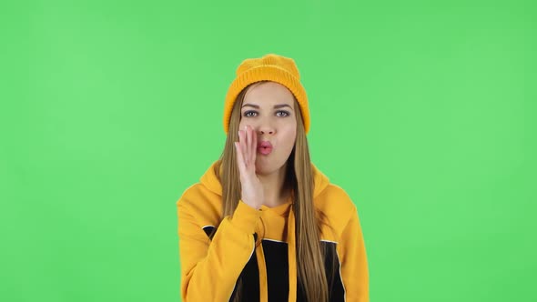 Portrait of Modern Girl in Yellow Hat Is Screaming Calling Someone. Green Screen