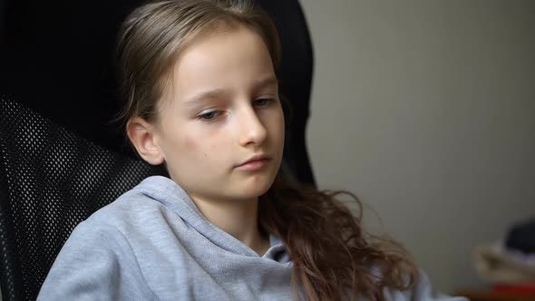 Little Sad Girl is Sitting on Black Office Chair Punishment Serious Face