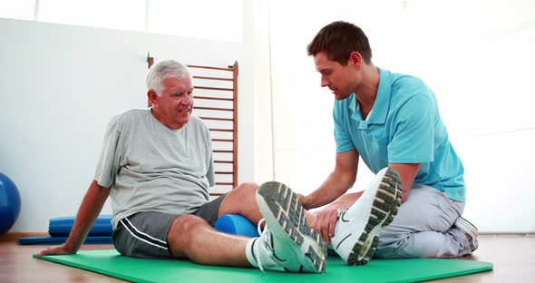 Physiotherapist Helping Patient with His Knee Mobility