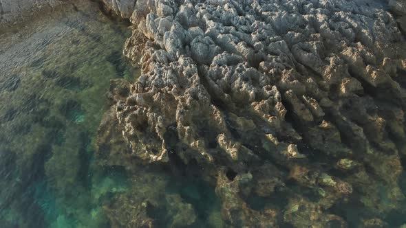 Parallax shot of a small reef on Cape Kamenjak, Croatia. Camera tilting up at the end of the shot.