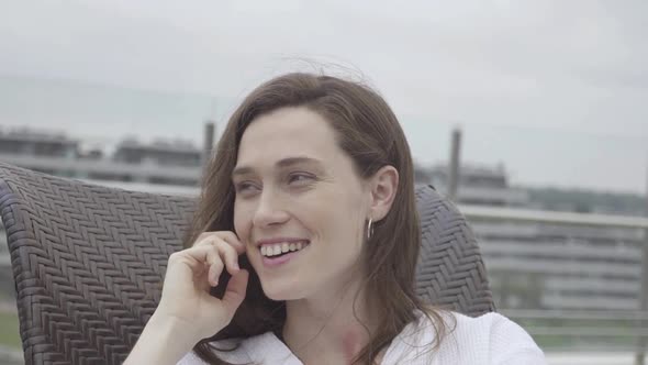 Young woman relaxing and smiling outdoors