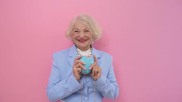 Cheerful Pensioner, Happy with Life, Smiles Happily Posing for the Camera in the Studio on an