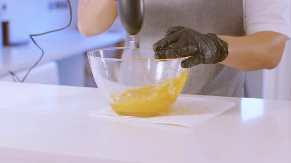 Cook Pours Sugar Into Raw Eggs And Mix With A Mixer
