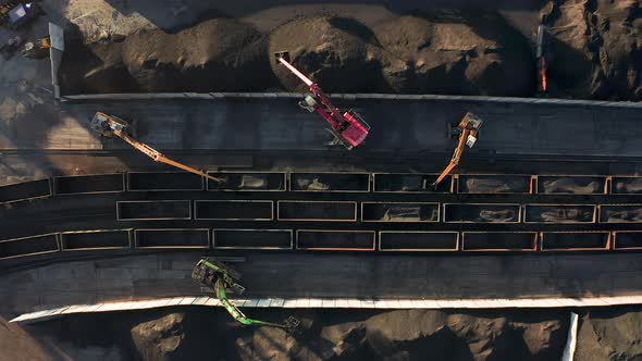 Excavators Unloading Coal From a Cargo Train