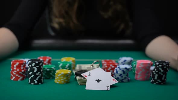 Woman Showing Aces Pair and Taking All Casino Chips and Money, Game Winner