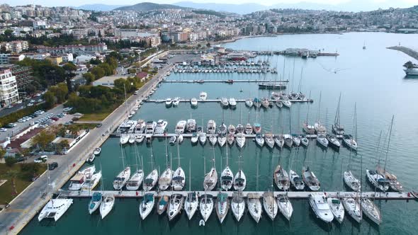 Flight over the marina with moored yachts and boats.