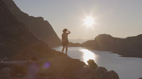 Adventurous Caucasian Adult Woman Hiking on Top of a Canadian Rocky Mountain