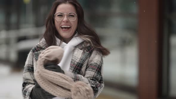 Funny Young Woman on Street at Winter Joking and Fooling Waving Her Hat