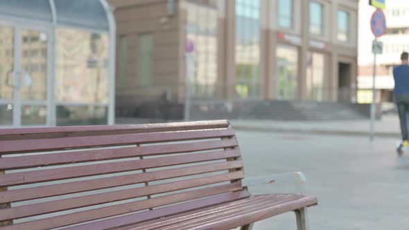 Old Man Coming and Sitting on Bench Outdoor