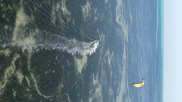 Vertical Video Kitesurfing Near the Shore of Zanzibar Tanzania Aerial View