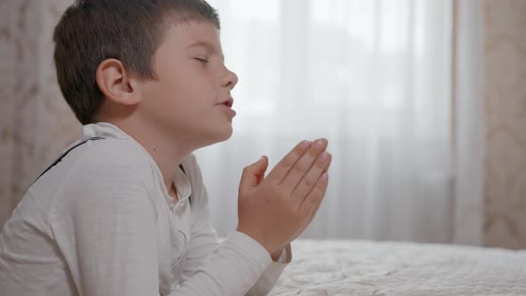 Trust in God, Prayer Male Child with Hope in His Heart and with Folded Together Arms, Prays To God