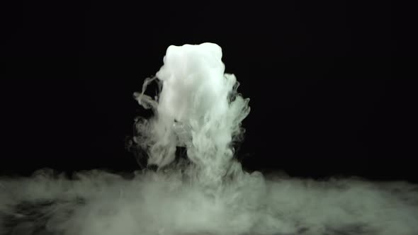 Glass of Champagne with the Effect of Dry Ice at Black Background