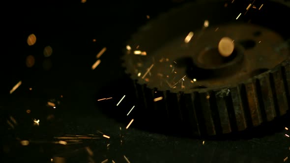 Sparks with gears in ultra slow motion 1500fps on a reflective surface - SPARKS w GEARS 