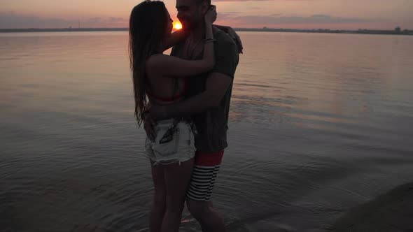 Couple Kissing on Beach at Sunset