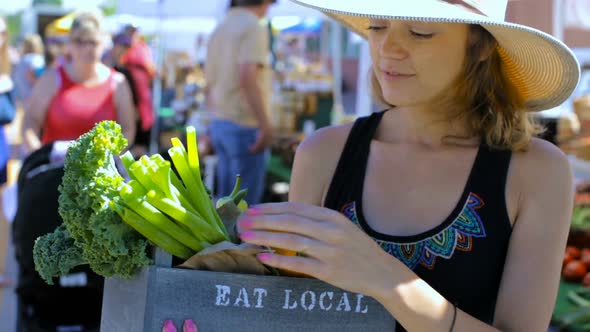 Young woman shopping at the local Farmers market.