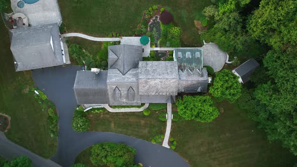 Bird's eye overhead shot of a large estate. Quiet and secluded property with a luxurious pool.