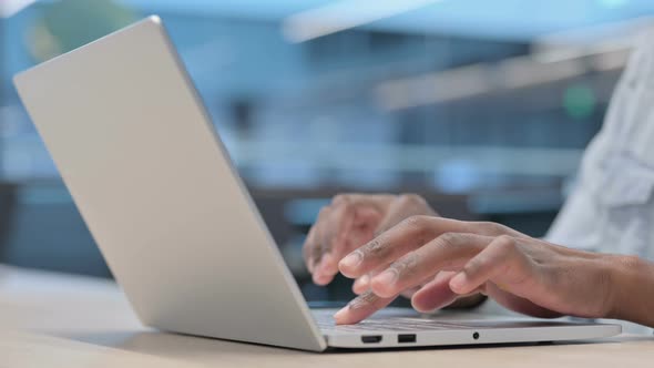 Hands Close up of African Man Typing on Laptop