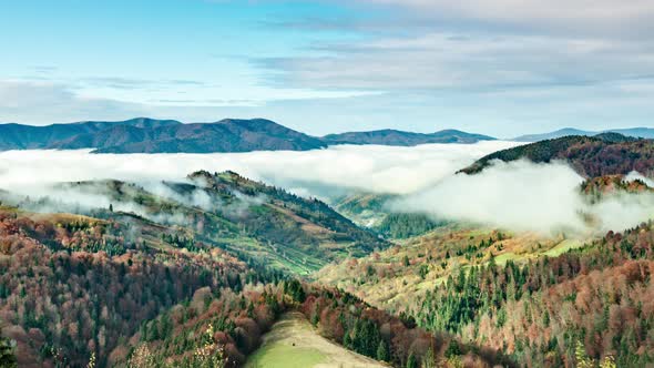 Landscapes of Green Hills Under a Layer of White and Fluffy Clouds