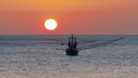 Fishing Boat in the Sea Against Sunset