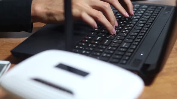 Woman Typing On A Laptop Using Wi Fi