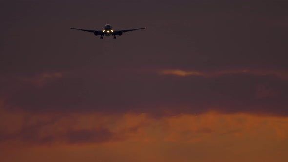 Airplane Approaching Over Ocean at Sunset Backgfround